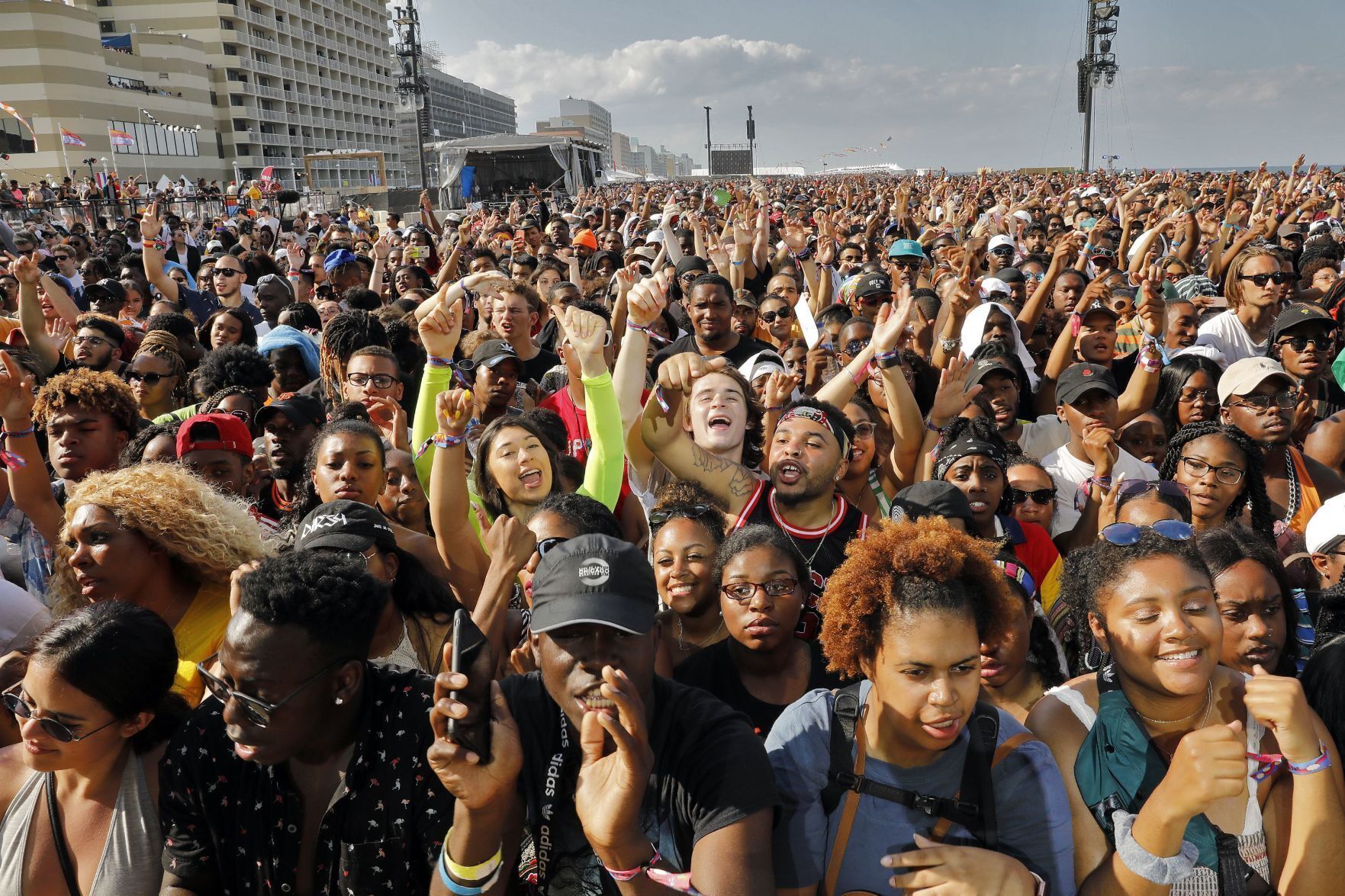 Fans cheer as Pusha-T performs during the Something in the Water festival in April 2019. Citing a "toxic energy" in Virginia Beach, organizer Pharrell Williams has opted to not bring the festival back. Fans plan a "sit-down" next month to show support for the star musician and Virginia Beach native. Jonathon Gruenke/staff file